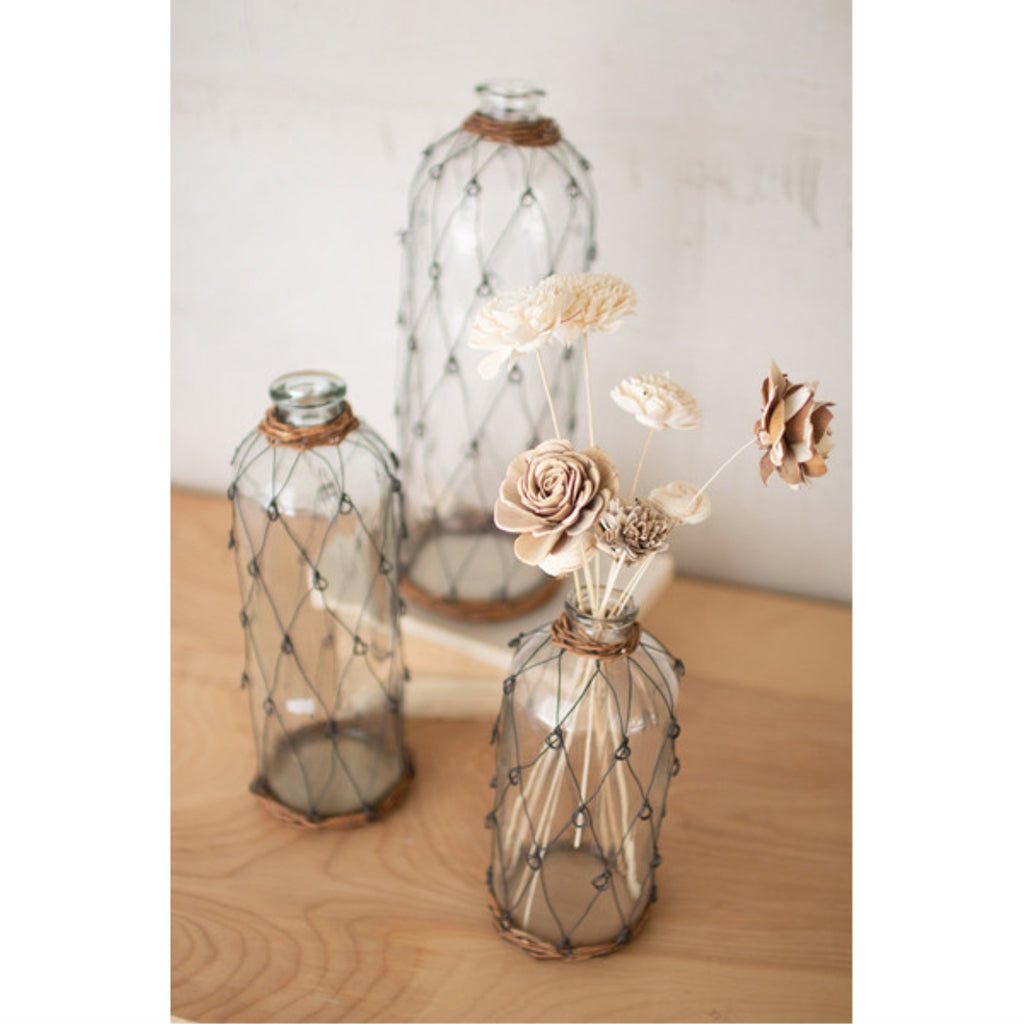 SET OF THREE TALL WIRE AND WICKER WRAPPED GLASS BOTTLES