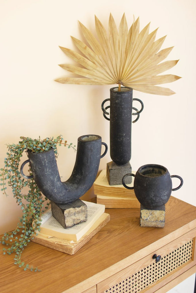 SET OF THREE BLACK MODERN CLAY VASES ON ROCK BASES